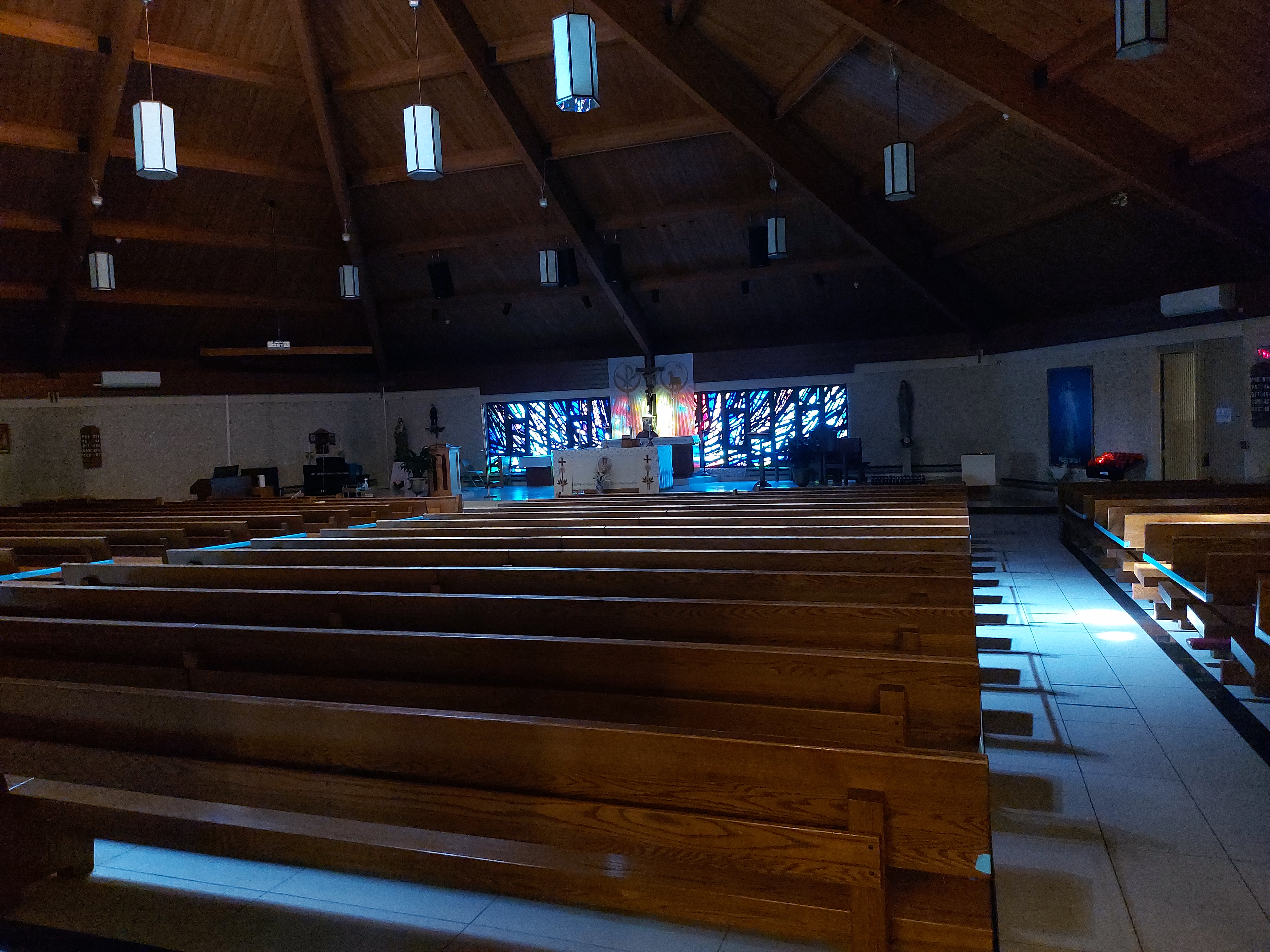 Image of the pews from the front of the church- in natural light