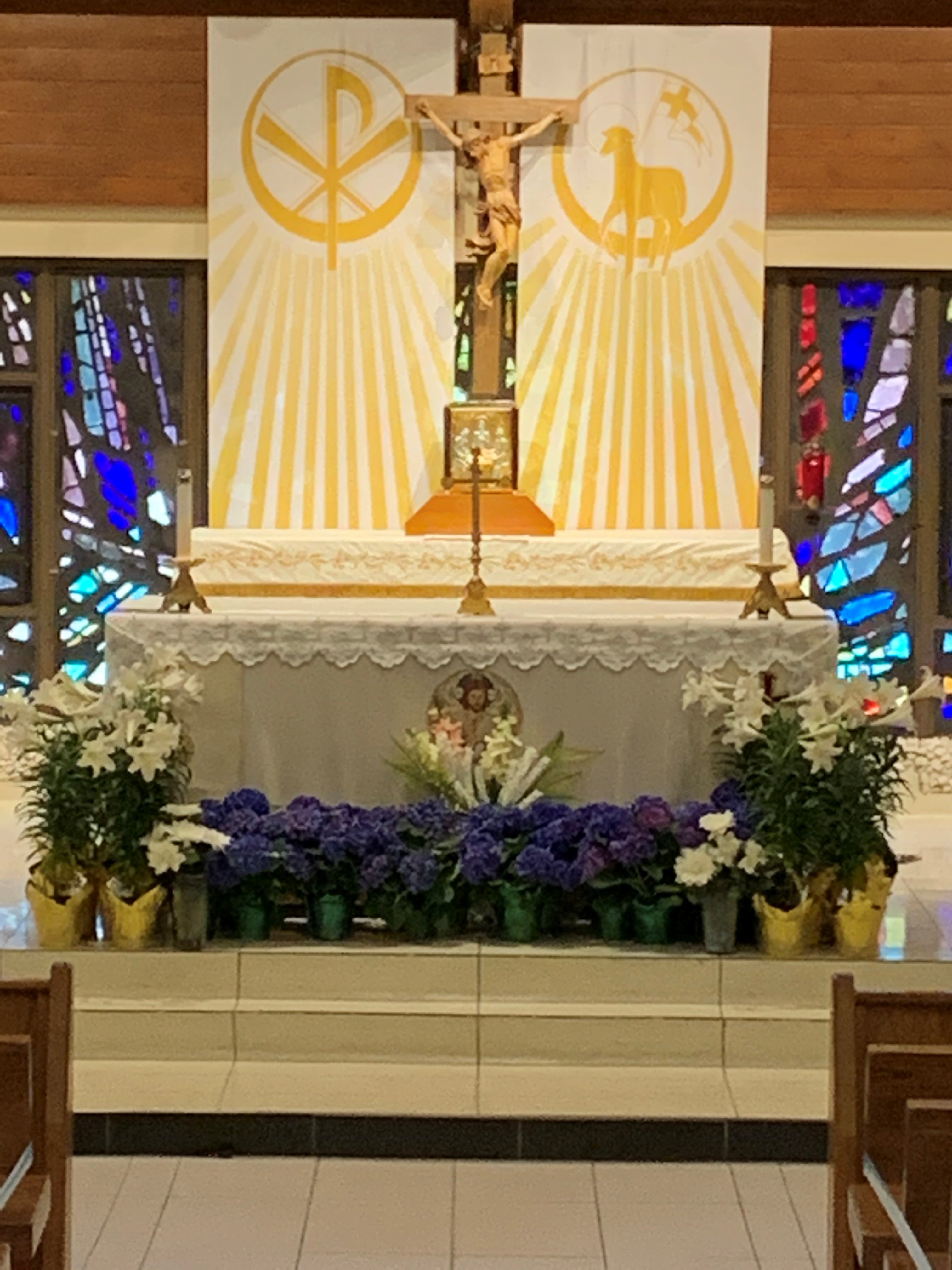 Easter Banners and Easter flowers decorate the Altar in the Sanctuary
